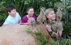 Robert Irwin and two guests with Meerkats perched on his shoulders.